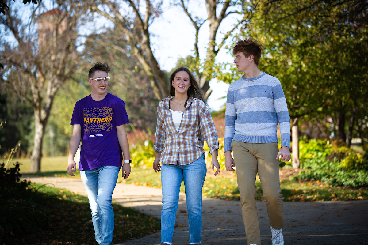 Three students walking on UNI campus